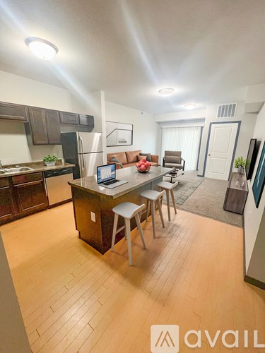 A kitchen with a table and chairs in the middle of the room.