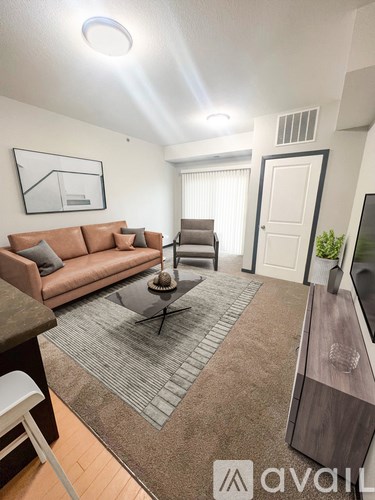 A living room with a brown couch and a coffee table.