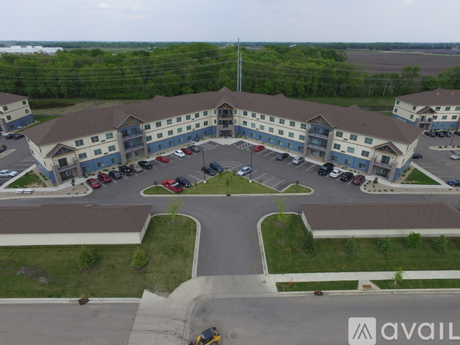 A parking lot in front of a building with the word AVAIL on it.