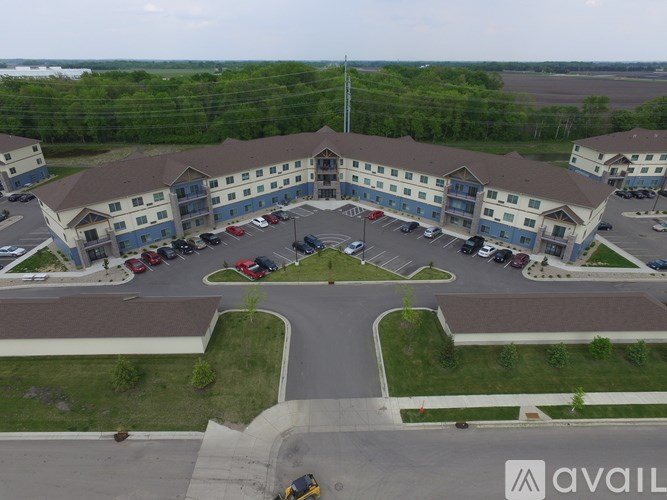 A parking lot in front of a building with the word AVAIL on it.