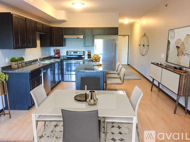 A modern kitchen with a dining table set for four.