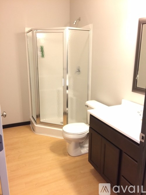 A bathroom with a toilet, sink, and shower.