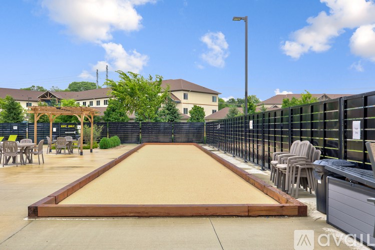 A shuffleboard court is in the middle of a patio area.
