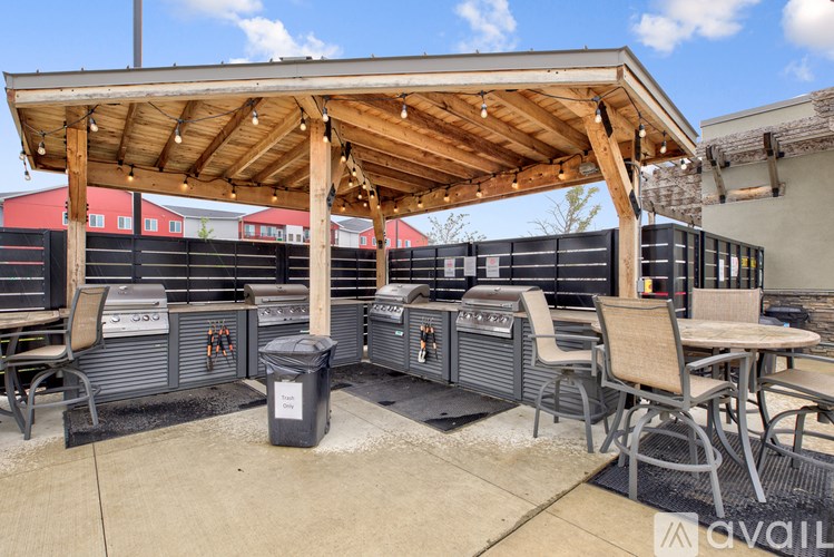 A patio area with a grill and seating area.