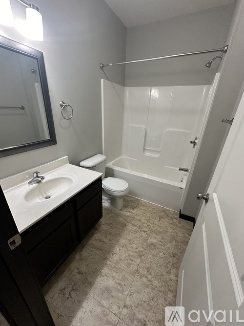 A bathroom with a sink, toilet, and bathtub.