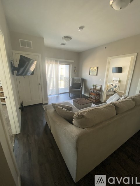 A living room with a couch and a television.