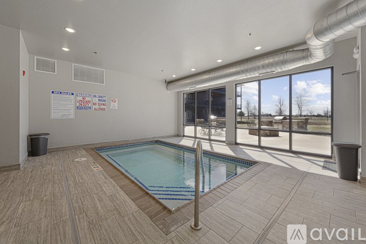 A large indoor swimming pool with a glass wall outside.
