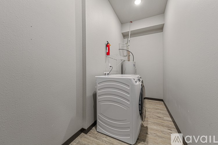 A white air conditioner unit is installed in a narrow hallway.