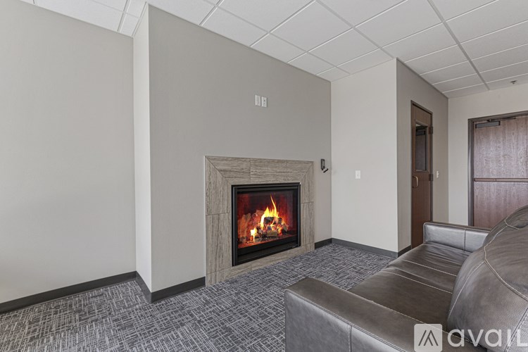A modern living room with a fireplace and a couch.