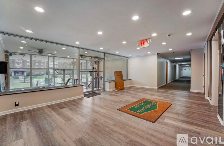 A room with wooden floors and a green mat on the floor.