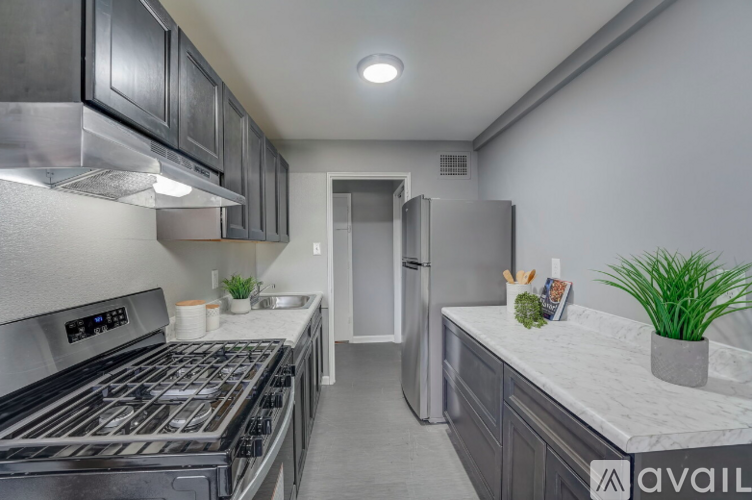 A modern kitchen with a stainless steel refrigerator and oven.