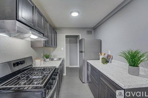 A modern kitchen with a stainless steel refrigerator and oven.