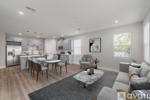 A modern kitchen and living room with a dining table and chairs.