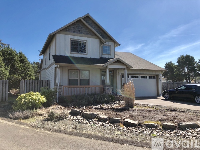 A house with a car parked in front of it.