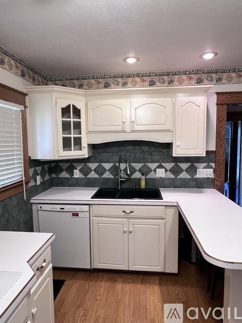 A kitchen with a table in the middle of it.