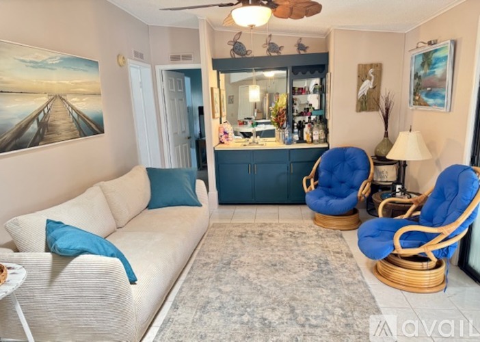 A bedroom with a bed covered in a shell-patterned comforter.