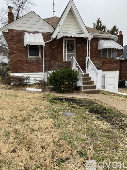 A house with a white front porch and a brick exterior.