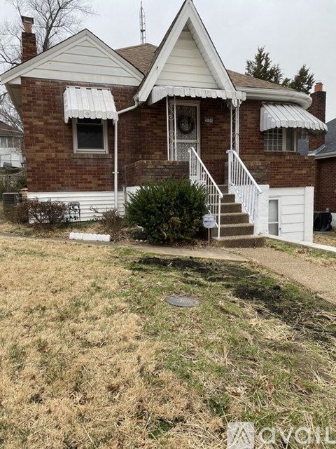 A house with a white front porch and a brick exterior.