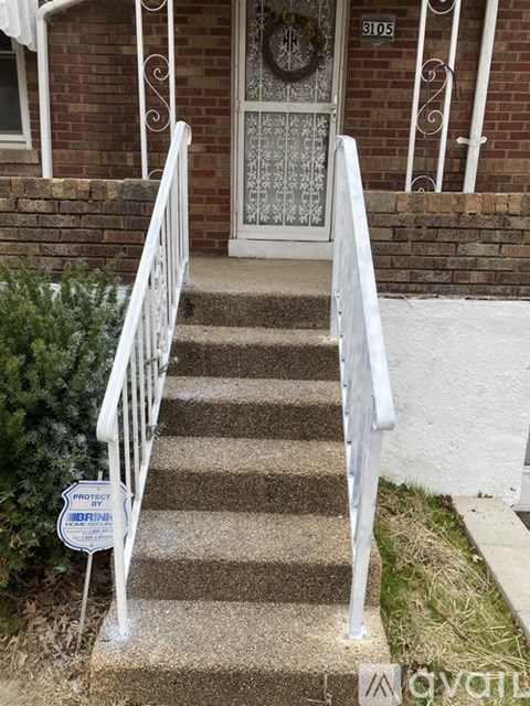 A set of stairs with a white railing and a sign that says "Protect by BRIM".