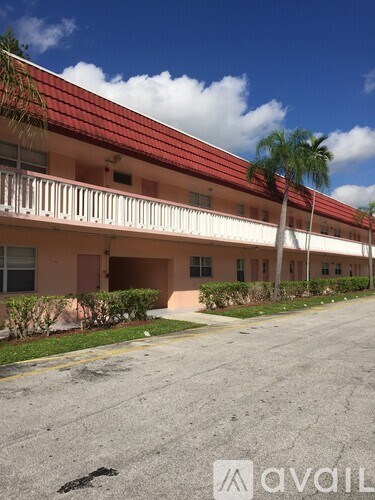 A building with a red roof and a balcony.