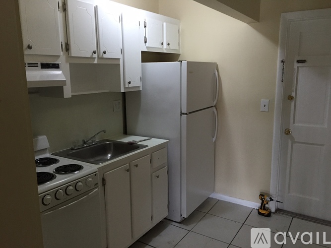 A kitchen with white appliances and cabinets.