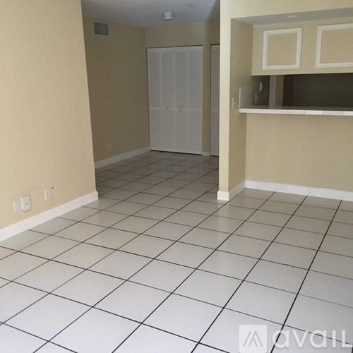 A room with a white tile floor and a white closet.