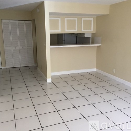 A room with a white tile floor and a white closet.