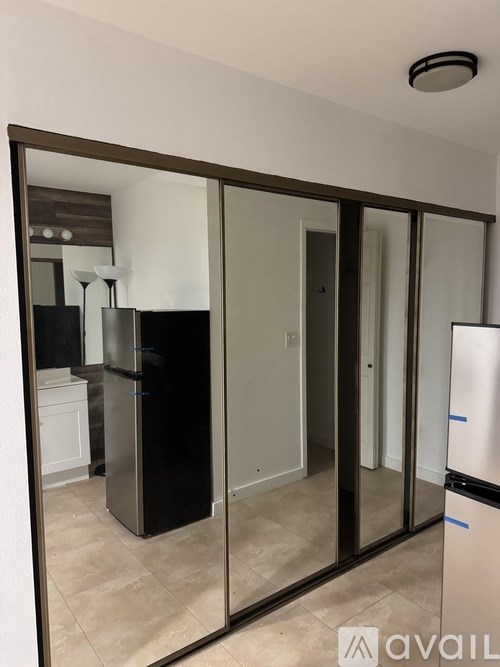 A bathroom with a white cabinet and a mirror above it.