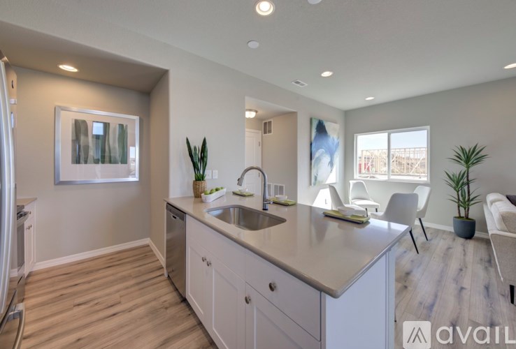 A modern kitchen with a large island and a view of the city.