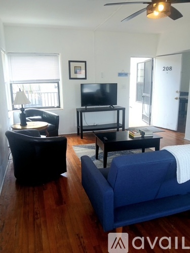 A living room with a blue couch and a television.