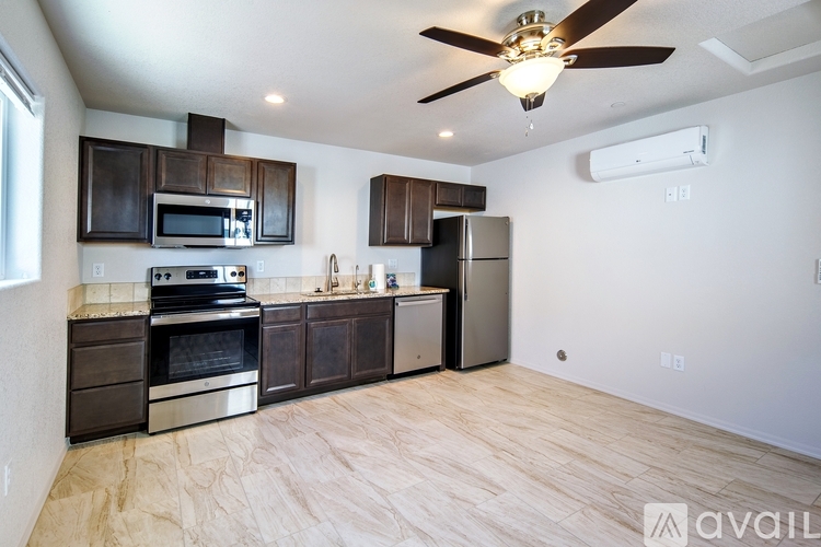 A kitchen with dark brown cabinets and stainless steel appliances.