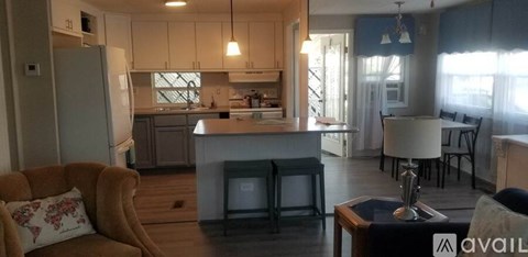 A kitchen with a table and chairs in the middle of the room.