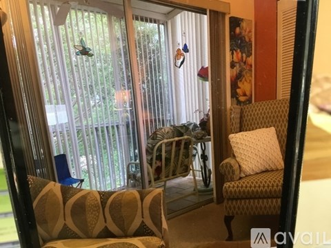 A living room with a couch and a chair.