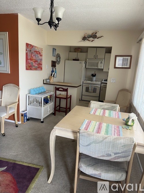 A kitchen with a table and chairs in it.