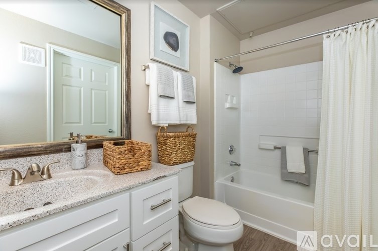 A bathroom with a toilet, sink, and bathtub.