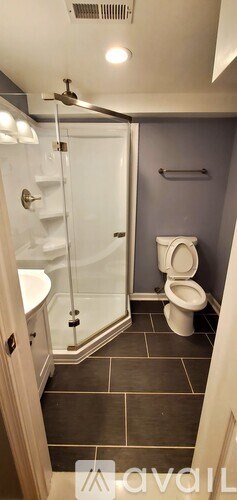 A bathroom with a toilet, sink, and shower.