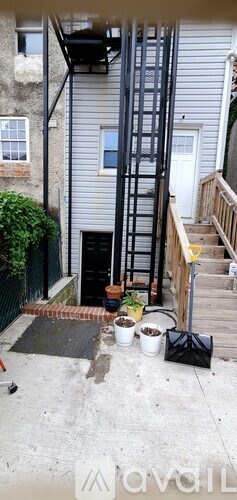 A ladder is leaning against the side of a house.