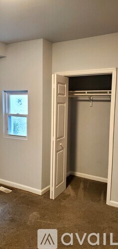 A room with a white door and a window.