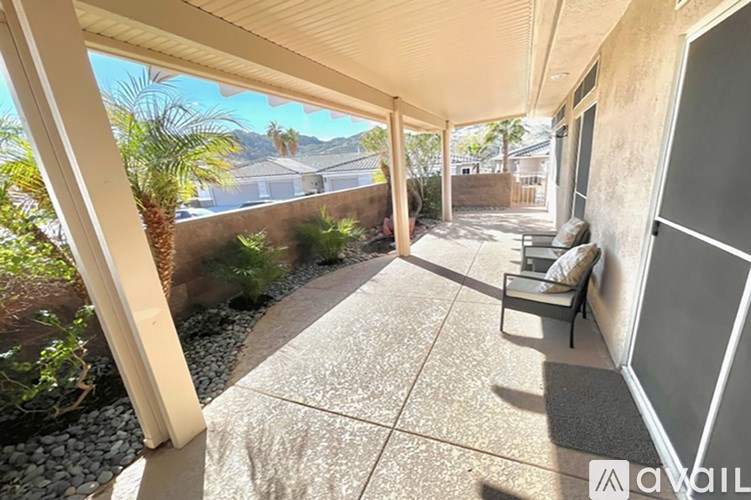 A patio with a bench and a table is shown.
