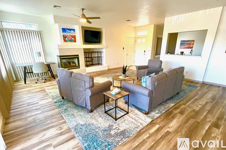 A living room with a fireplace and a television.