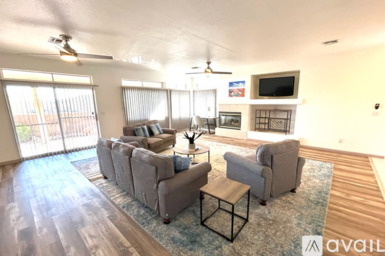 A living room with a grey couch and a television.