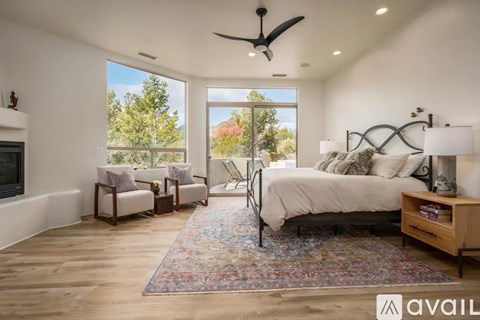 A bedroom with a large bed and a fireplace.