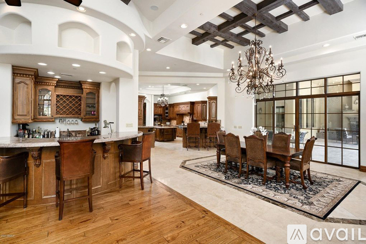 A large, well-lit dining room with a wooden table and chairs.
