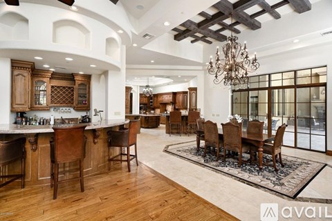 A large, well-lit dining room with a wooden table and chairs.