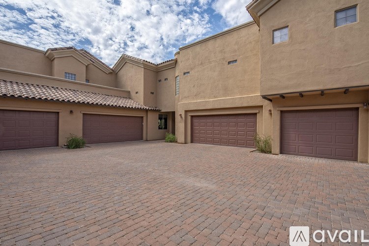 A house with a large driveway and two garages.
