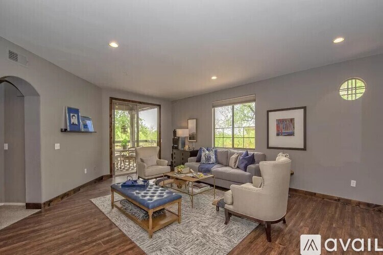 A living room with a couch, chair, and coffee table.