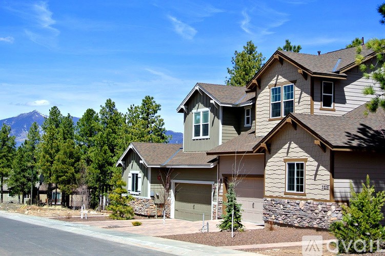 A row of houses with a mountain in the background.