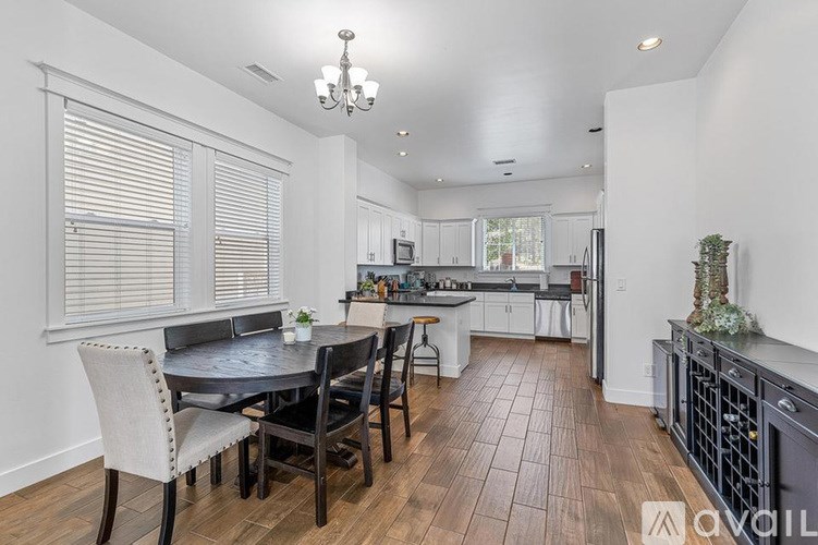 A dining room with a table set for four.