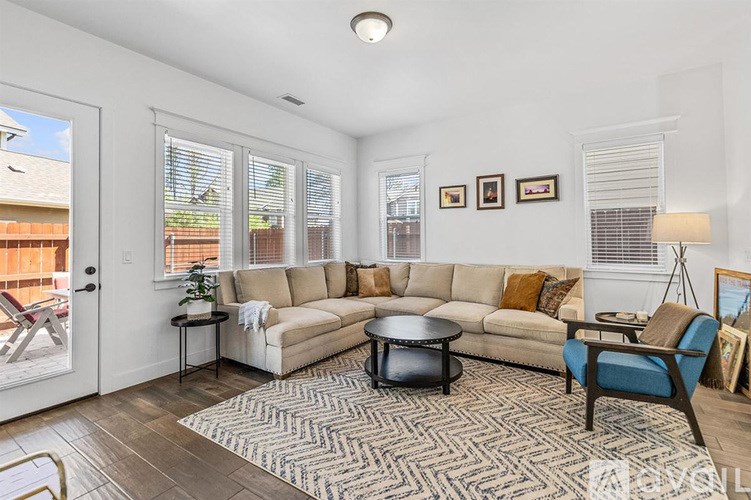 A living room with a couch, chair, and coffee table.