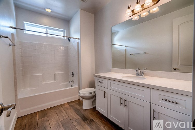 A bathroom with a toilet, sink, and a walk-in shower.